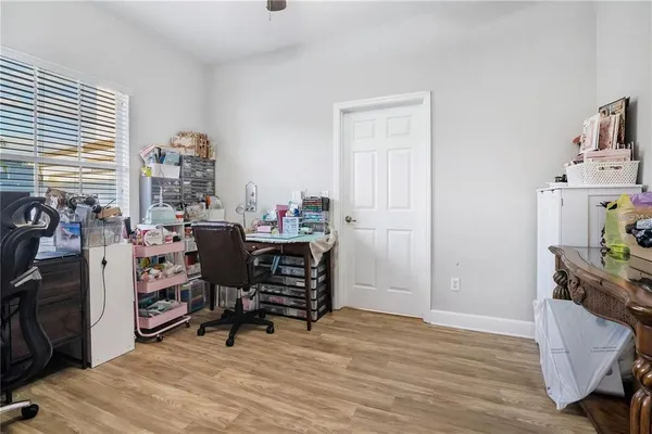 a view of a workspace with furniture and a window
