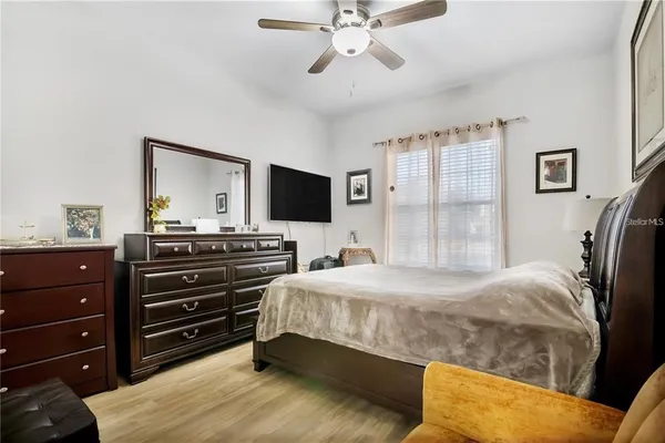 a bedroom with a bed and wooden floor