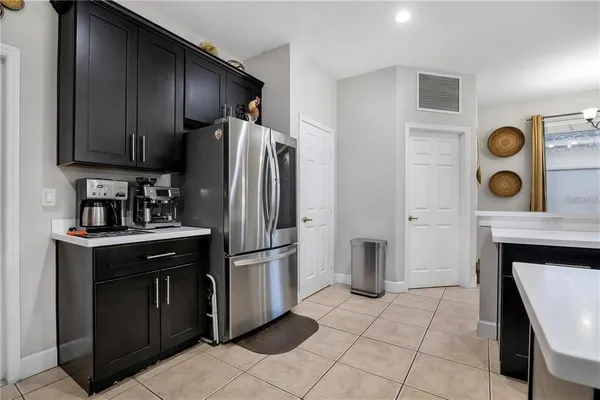 a kitchen with a refrigerator and a stove top oven