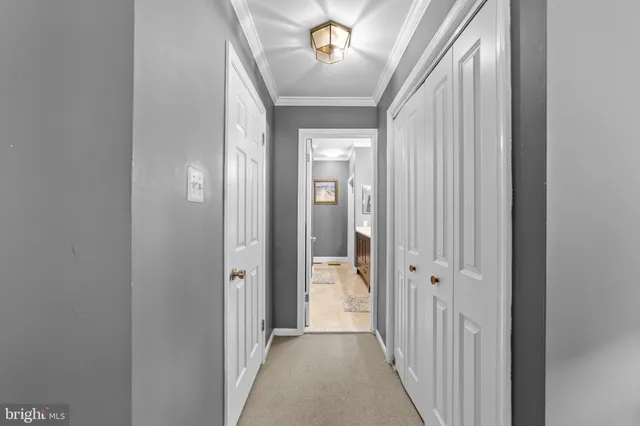 a view of a hallway with a chandelier fan