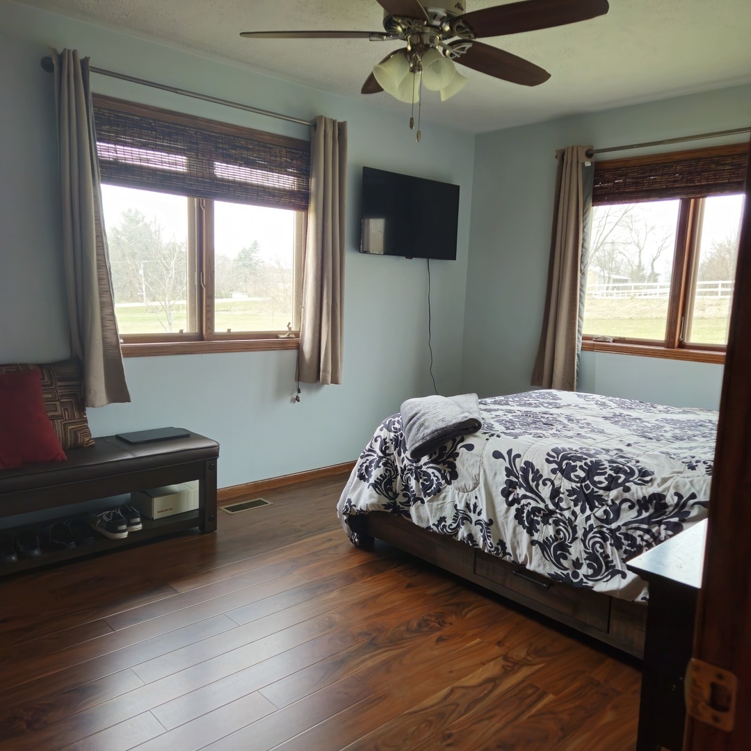 5096 Rotary Road Cherry Valley, IL 61016 - Photo 11 of 28 a bedroom with a bed and a flat tv screen on dresser