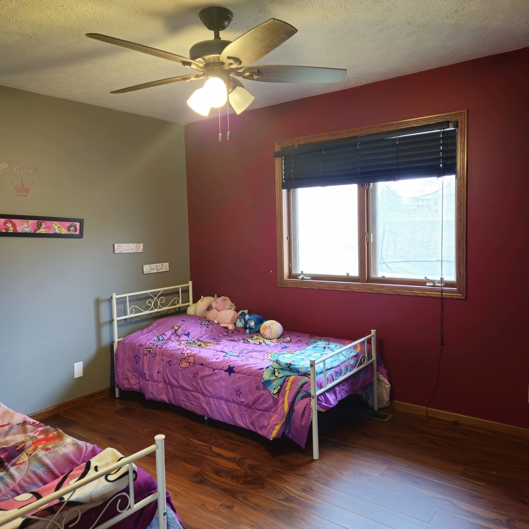5096 Rotary Road Cherry Valley, IL 61016 - Photo 12 of 28 a bedroom with a bed table and a window
