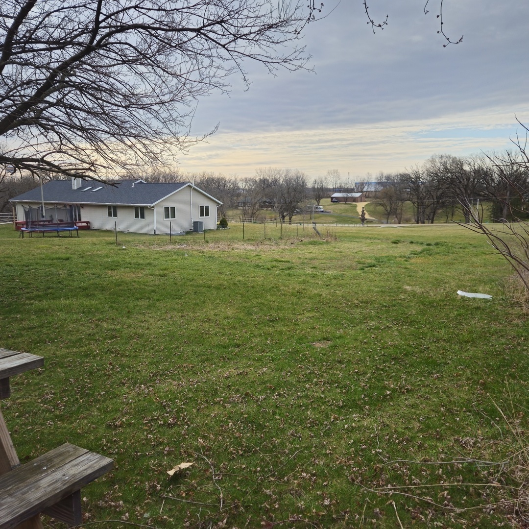 5096 Rotary Road Cherry Valley, IL 61016 - Photo 16 of 28 a view of a big yard next to a building