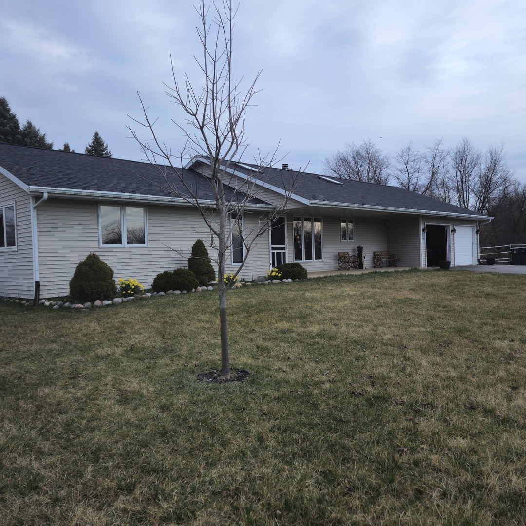 5096 Rotary Road Cherry Valley, IL 61016 - Photo 2 of 28 a house view with a garden space
