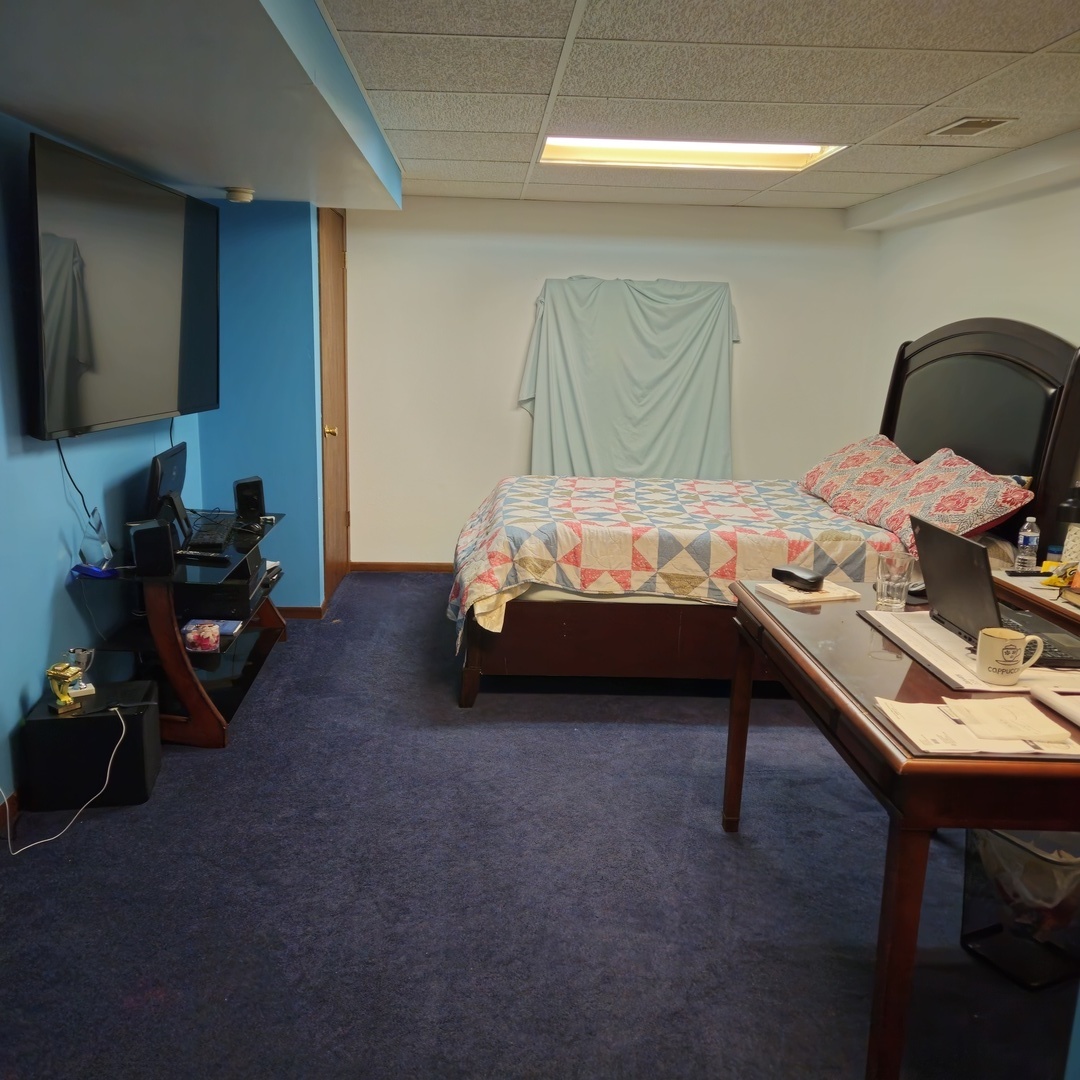 5096 Rotary Road Cherry Valley, IL 61016 - Photo 22 of 28 a bedroom with a bed and a computer on the desk