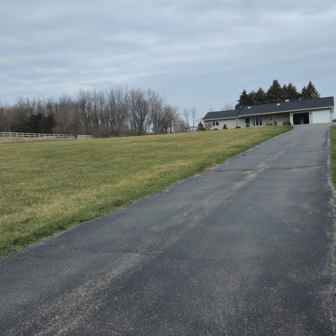 5096 Rotary Road Cherry Valley, IL 61016 - Photo 4 of 28 a view of a golf course with a lake