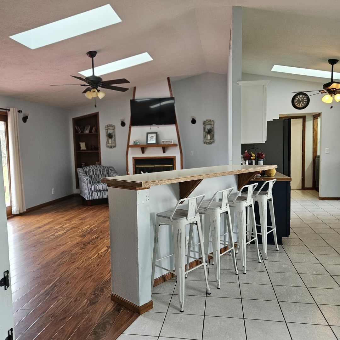 5096 Rotary Road Cherry Valley, IL 61016 - Photo 6 of 28 a kitchen with stainless steel appliances granite countertop a table chairs and a refrigerator