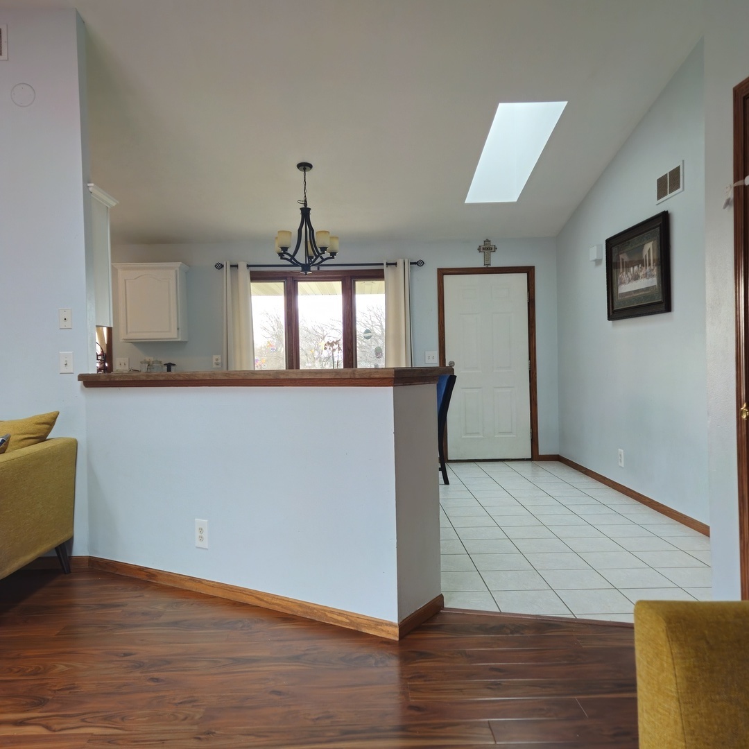5096 Rotary Road Cherry Valley, IL 61016 - Photo 7 of 28 a view of a kitchen with wooden floor and staircase