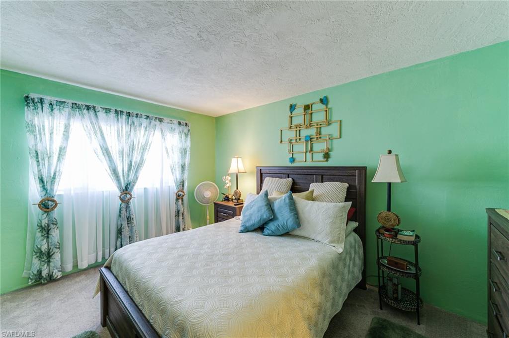2100 Barkeley Lane, Unit 13 Fort Myers, FL 33907 - Photo 12 of 12 a bedroom with a bed and a window