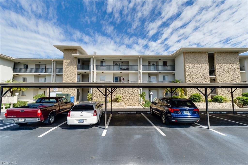 2100 Barkeley Lane, Unit 13 Fort Myers, FL 33907 - Photo 2 of 12 a car parked in front of a building