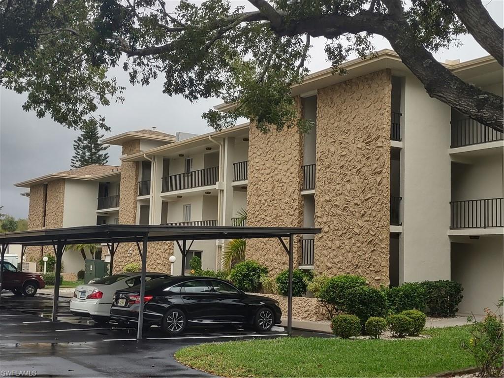 2100 Barkeley Lane, Unit 13 Fort Myers, FL 33907 - Photo 3 of 12 a front view of a house with a yard