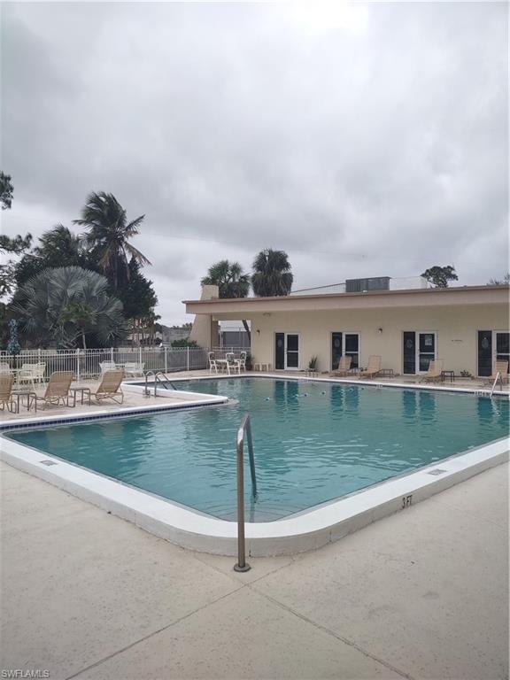 2100 Barkeley Lane, Unit 13 Fort Myers, FL 33907 - Photo 5 of 12 a view of a swimming pool with a yard