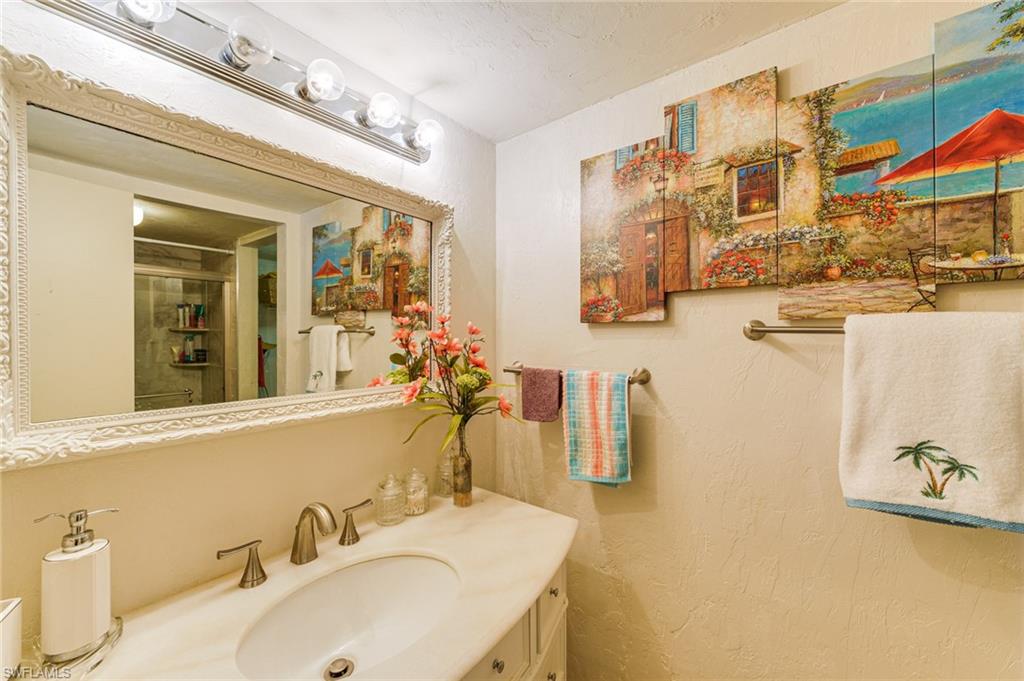 2100 Barkeley Lane, Unit 13 Fort Myers, FL 33907 - Photo 6 of 12 a bathroom with a sink and a mirror