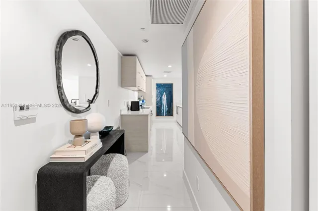 a living room with furniture and a mirror