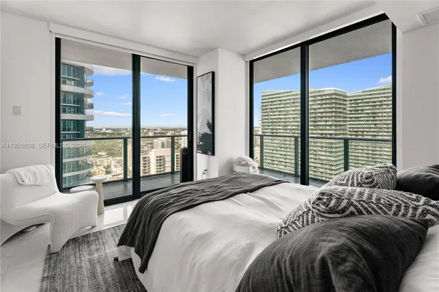 a bedroom with a large bed and a large window