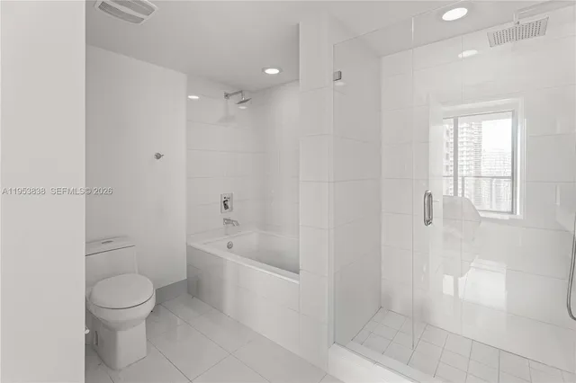 a bathroom with a bathtub shower sink vanity and toilet