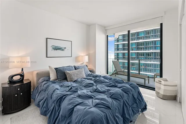 a bed sitting in a bedroom next to a window