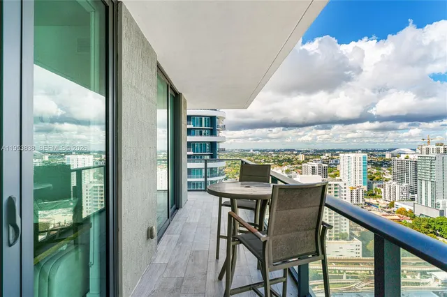 a view of a balcony with table and chairs