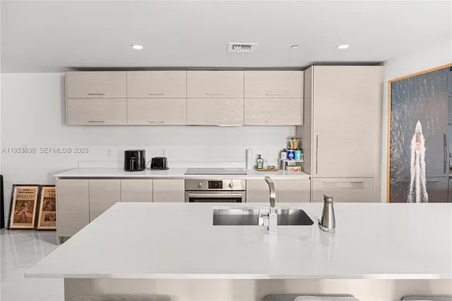 a kitchen with stainless steel appliances and white cabinets