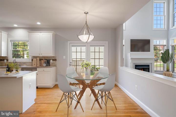 2038 Madrillon Road Vienna, VA 22182 - Photo 11 of 63 a view of a dining room with furniture window and wooden floor