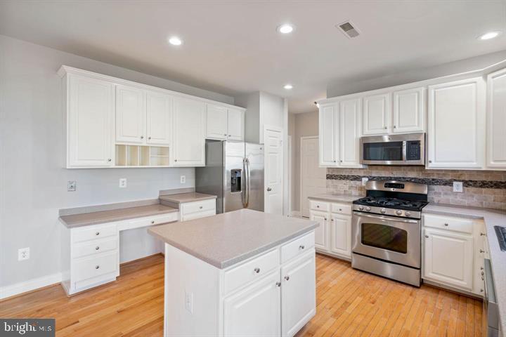 2038 Madrillon Road Vienna, VA 22182 - Photo 14 of 63 a kitchen with stainless steel appliances a sink stove and refrigerator