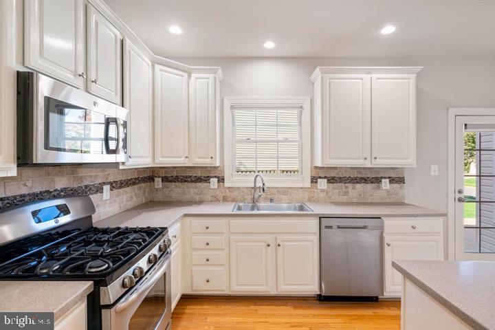 2038 Madrillon Road Vienna, VA 22182 - Photo 15 of 63 a kitchen with a sink stove and cabinets