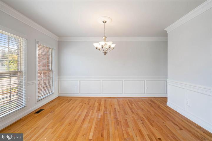 2038 Madrillon Road Vienna, VA 22182 - Photo 21 of 63 a view of a room with wooden floor and chandelier