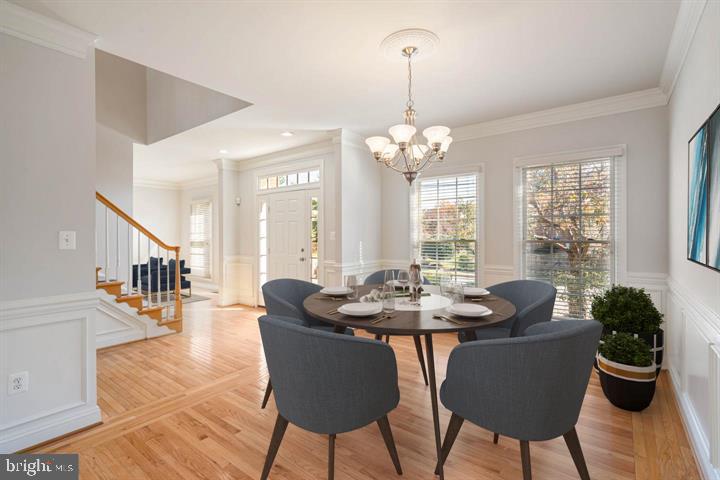 2038 Madrillon Road Vienna, VA 22182 - Photo 23 of 63 a dining room with furniture a chandelier and wooden floor