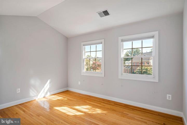2038 Madrillon Road Vienna, VA 22182 - Photo 37 of 63 a view of an empty room with wooden floor and a window