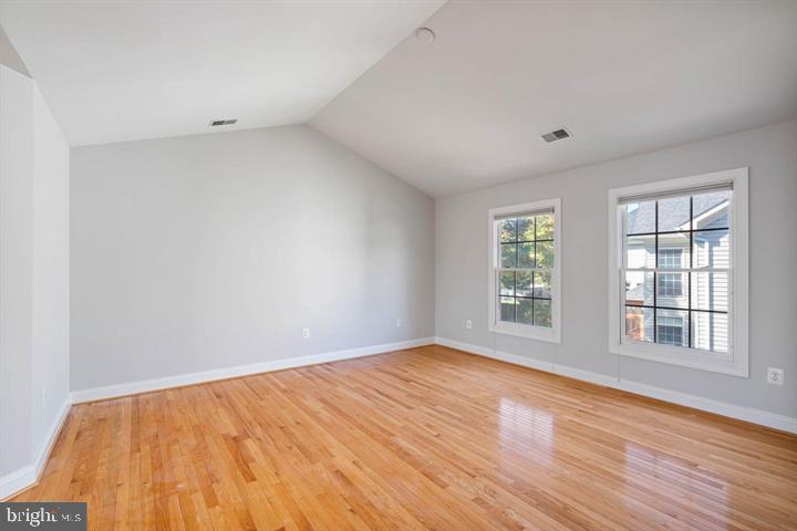 2038 Madrillon Road Vienna, VA 22182 - Photo 38 of 63 an empty room with wooden floor and windows