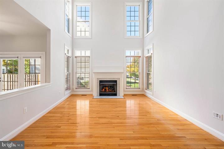 2038 Madrillon Road Vienna, VA 22182 - Photo 4 of 63 a view of an empty room with wooden floor fireplace and a window