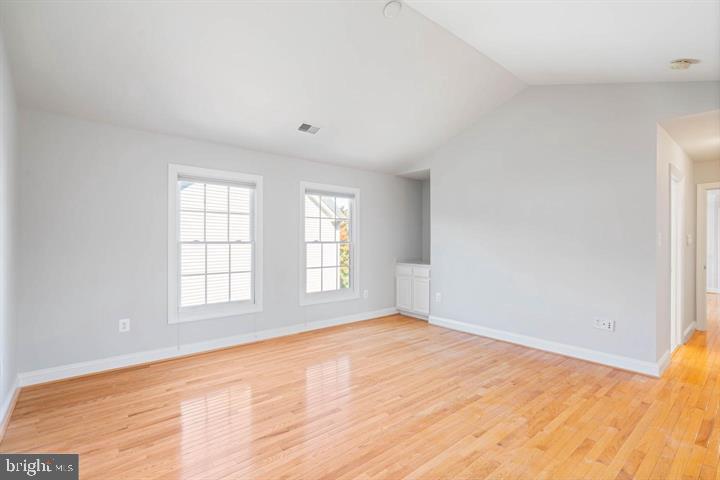 2038 Madrillon Road Vienna, VA 22182 - Photo 41 of 63 an empty room with wooden floor and windows