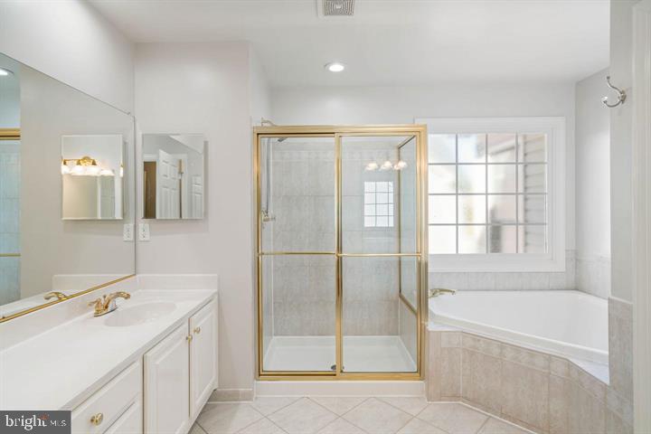 2038 Madrillon Road Vienna, VA 22182 - Photo 44 of 63 a bathroom with a tub sink and mirror