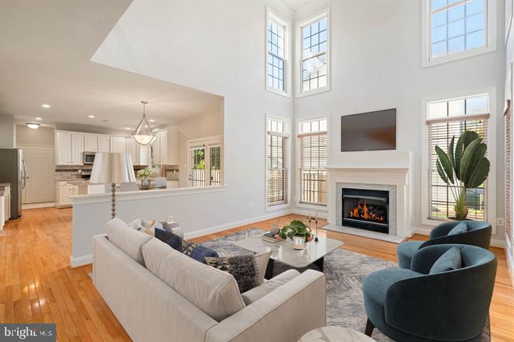 2038 Madrillon Road Vienna, VA 22182 - Photo 6 of 63 a living room with furniture a flat screen tv and a fireplace