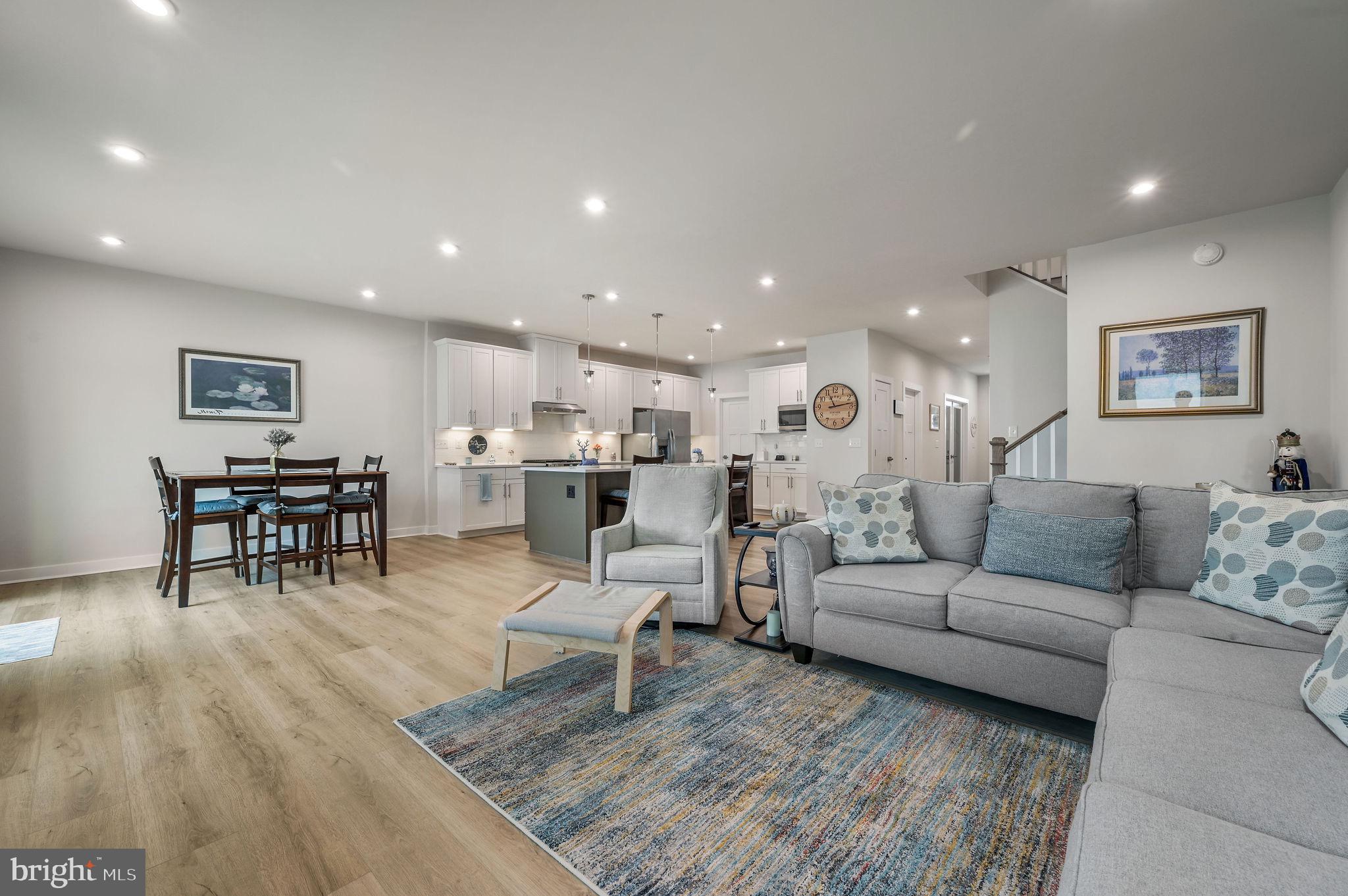 30366 Indigo Way Georgetown, DE 19947 - Photo 14 of 37 a living room with furniture and a dining table with kitchen view