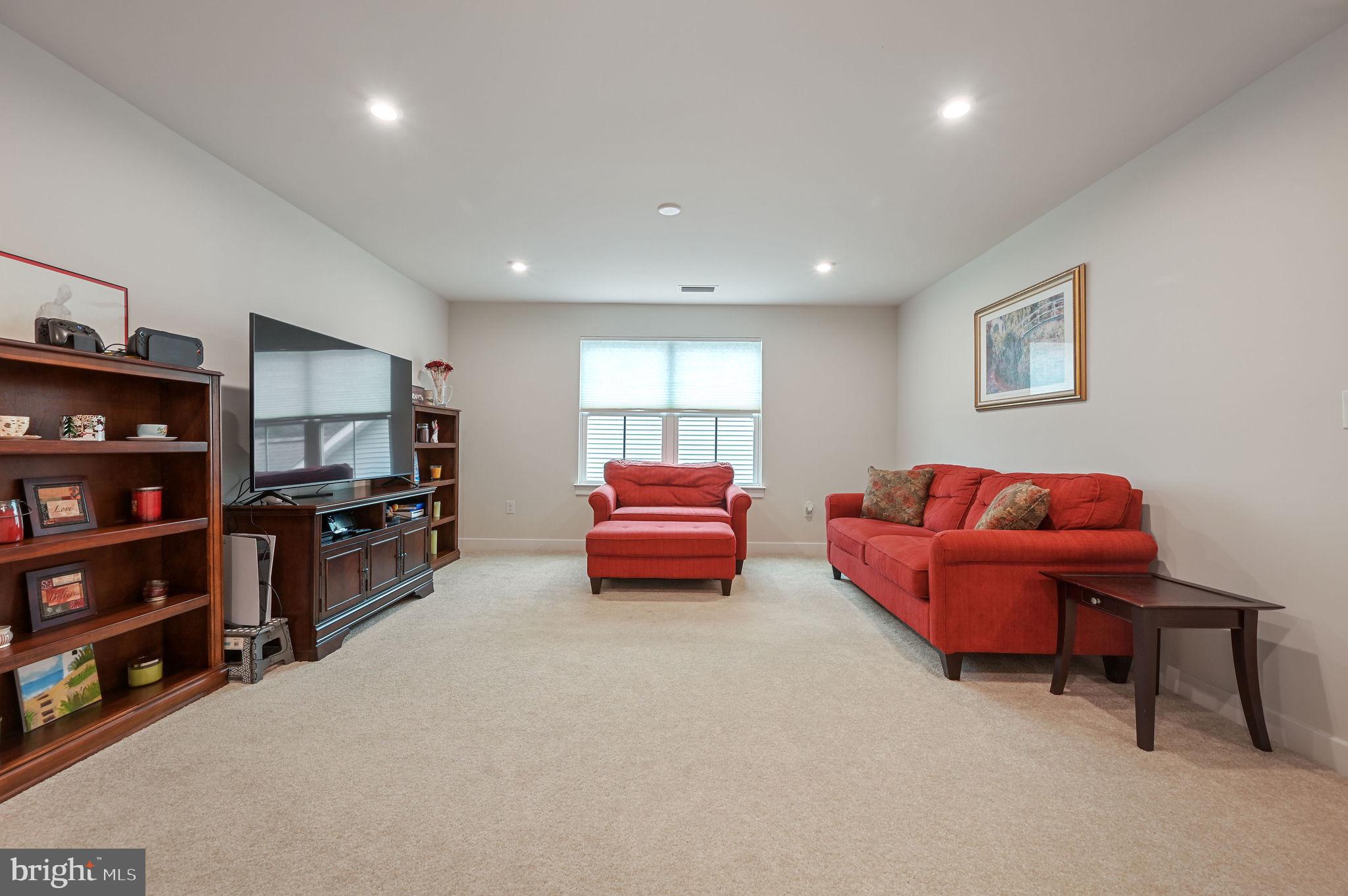 30366 Indigo Way Georgetown, DE 19947 - Photo 26 of 37 a living room with furniture and a book shelf
