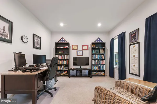 a livingroom with workspace and a couch