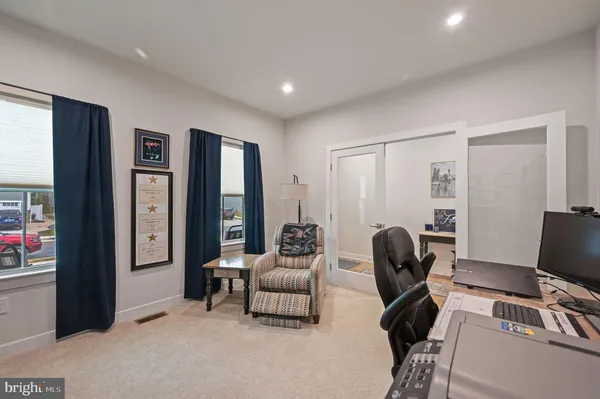 a view of living room with furniture and wooden floor