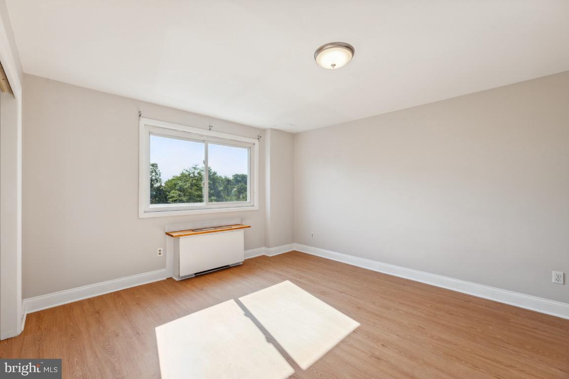 5101 8th Road South, Unit 310 Arlington, VA 22204 - Photo 17 of 28 an empty room with wooden floor and windows