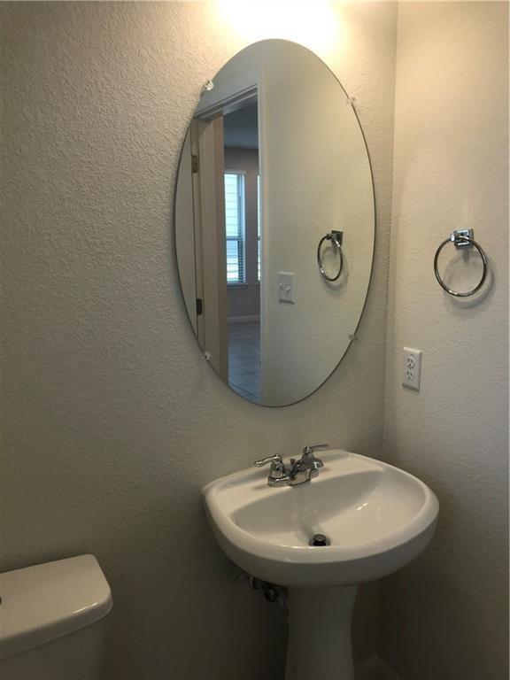 115 Iron Rail Road Dripping Springs, TX 78620 - Photo 6 of 16 Bathroom featuring toilet and a textured wall