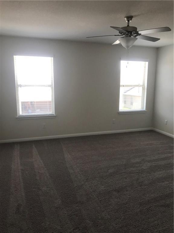 115 Iron Rail Road Dripping Springs, TX 78620 - Photo 7 of 16 Spare room featuring dark colored carpet and ceiling fan