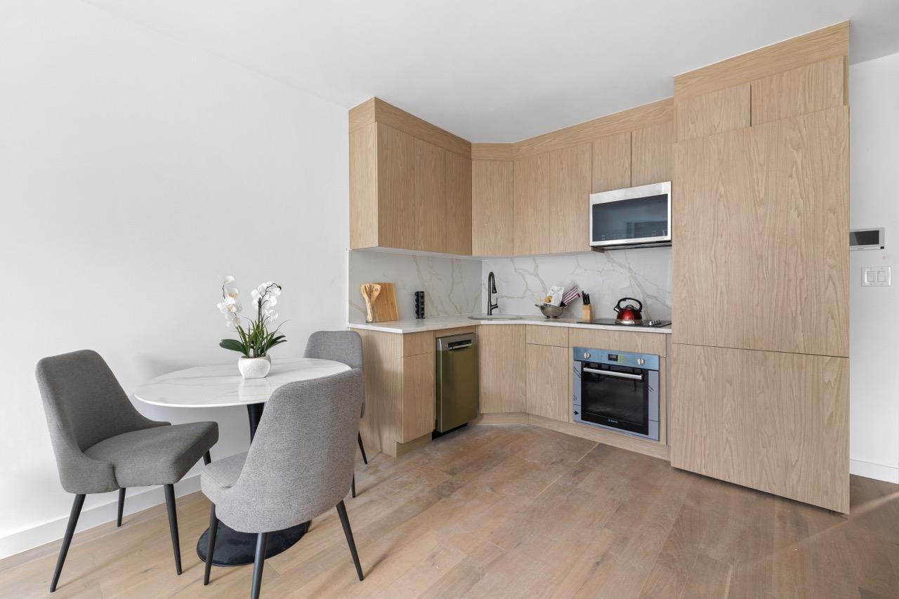1220 Putnam Avenue, Unit 3B Brooklyn, NY 11221 - Photo 2 of 6 a view of kitchen with cabinets and wooden floor