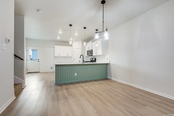 a kitchen with stainless steel appliances kitchen island a refrigerator and a sink