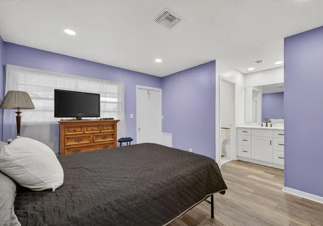 a spacious bathroom with a granite countertop sink and a mirror