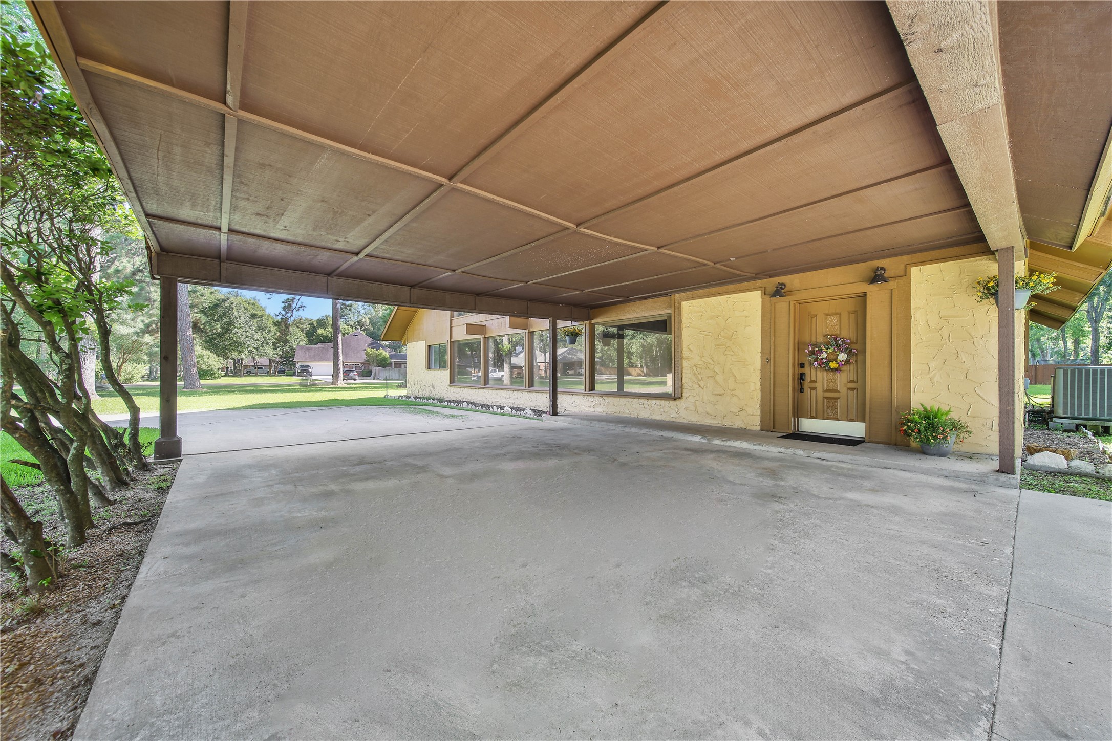 15418 Willis Way Conroe, TX 77384 - Photo 14 of 41 Large port cochere with space for four vehicles in the circle drive