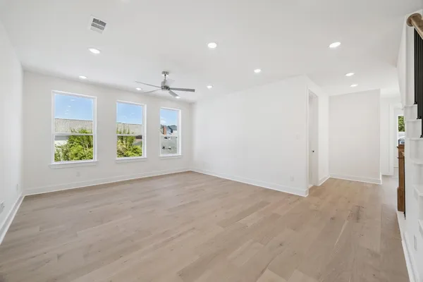 a view of an empty room with windows and garden
