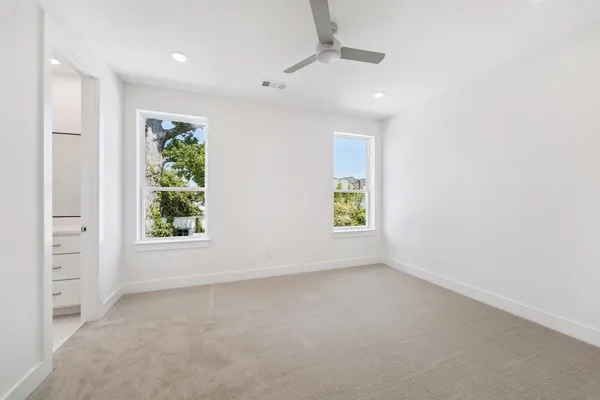 an empty room with windows and closet