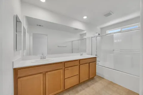a bathroom with a double vanity sink and mirror