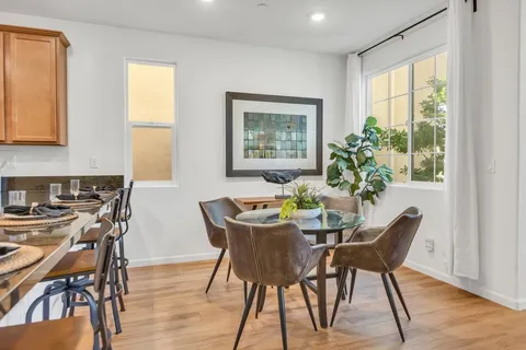 a dining room with furniture and wooden floor