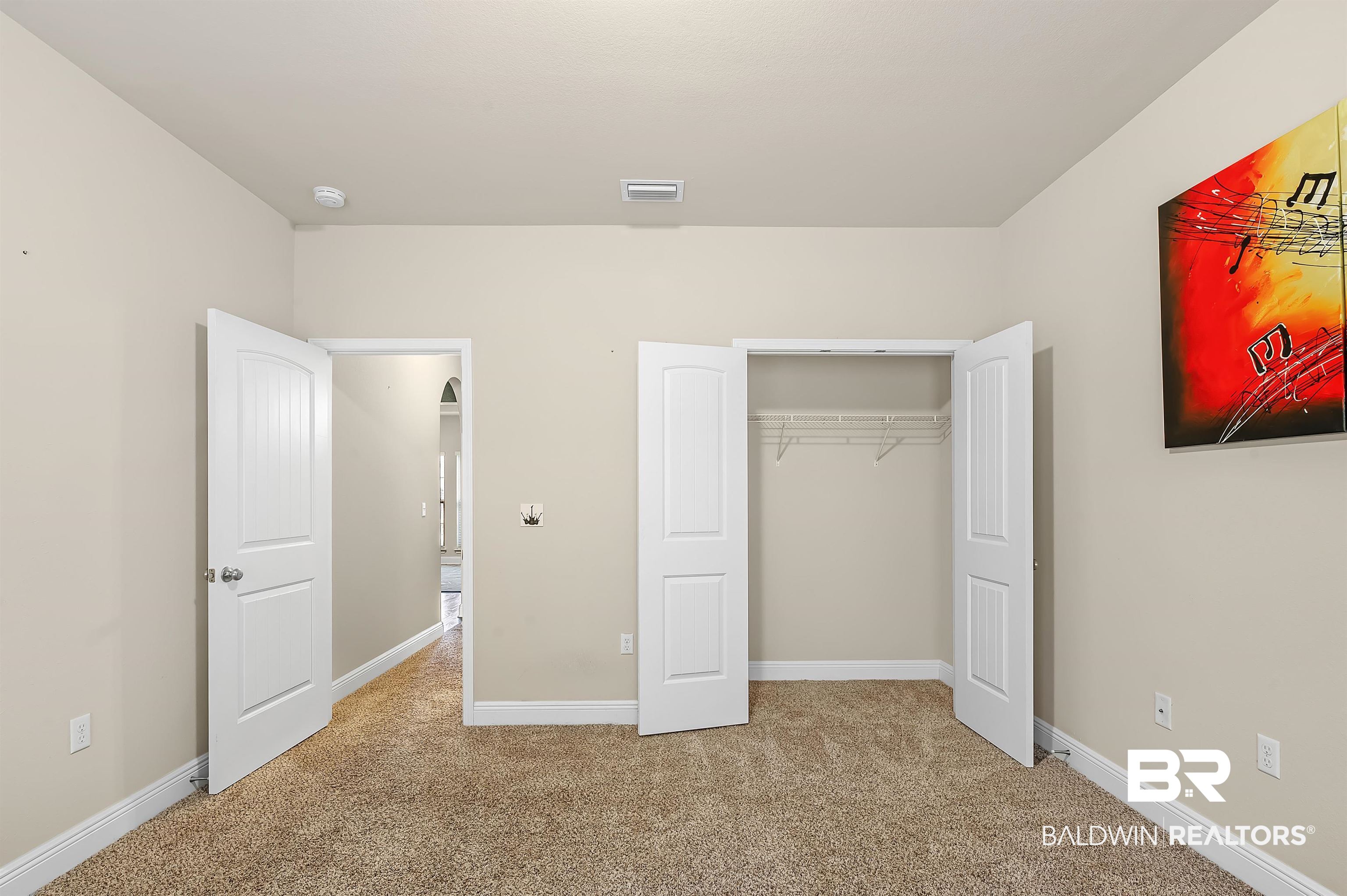 1086 Melbourne Court Foley, AL 36535 - Photo 31 of 43 Unfurnished bedroom featuring a closet and light colored carpet